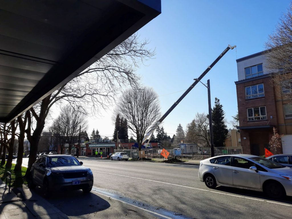 A crane sets to work on construction site at Stone Way and Allen Street.