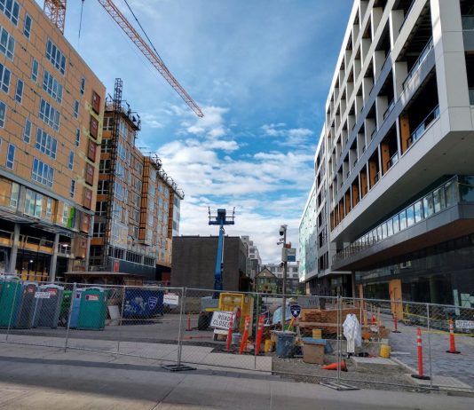 Growing Social Housing in Seattle Seven-story midrise apartments along a pedestrian plaza.