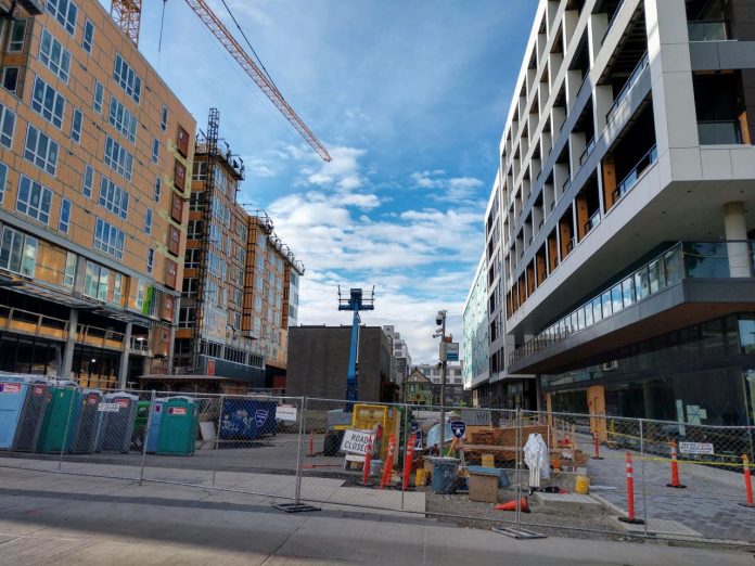 Capitol Hill TOD Seven-story midrise apartments along a pedestrian plaza.