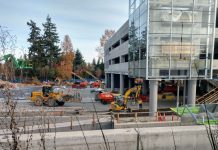 Shelving Parking Plans Would Help Keep ST3 Transit on Schedule Construction workers and heavy equipment at the light rail station near Microsoft's Redmond headquarters.