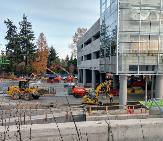 Sound Transit Plans Paid Parking Program as it Builds Another 8,000 Stalls Construction workers and heavy equipment at the light rail station near Microsoft's Redmond headquarters.