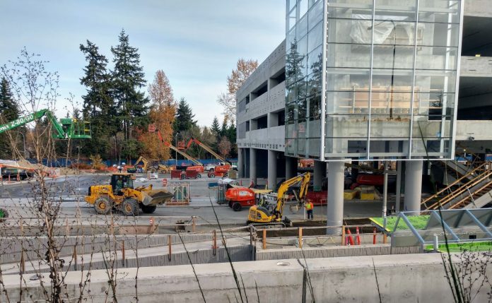 Construction workers and heavy equipment at the light rail station near Microsoft's Redmond headquarters.