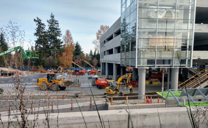Redmond Tech Center Station Construction workers and heavy equipment at the light rail station near Microsoft's Redmond headquarters.