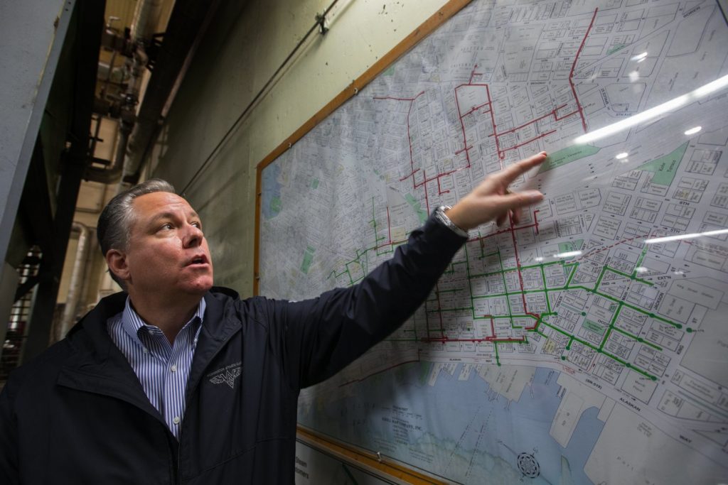 David Easton of Enwave Seattle, formerly Seattle Steam, points to a chart of steam lines running underneath Seattle. (Credit: Ellen M. Banner / The Seattle Times)