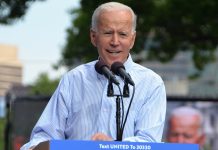 Biden’s Jobs Plan Is Big, but Not Big Enough to Revolutionize Housing, Rail, and Broadband Joe Biden in a blue collar behind a lectern with Biden for President on it.