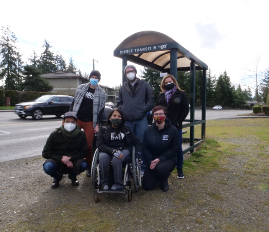 BIPOC and Disability Advocates Zero In on Highway Spending A woman in a wheelchair and five other advocates at a Tacoma bus stop.