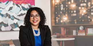Brianna Thomas portrait. She wears glasses and a pearl necklace.