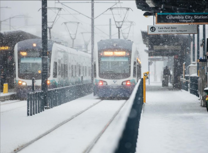 Two Link trains at Columbia City Station in the February snow.
