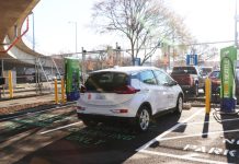 City Light Adds to Waterfront ‘Bait-and-Switch’ with Belltown Surface Parking Lot Proposal A white SUV next to a charging port.