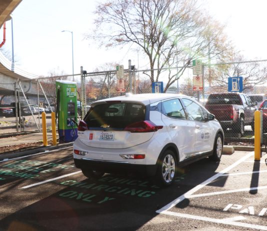 City Light Plans Electric Car Charging Lot in the Heart of Ballard A white SUV next to a charging port.