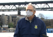 No New Highways Is a 21st Century Imperative Governor Inslee with a mask speaking in front of I-5 Ship Canal Bridge.