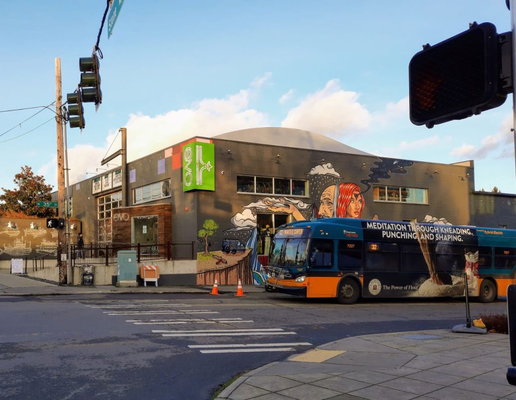 A Metro bus with the Evo store mural in the background.