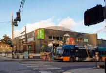 Metro Looks Toward Post-Pandemic Recovery, But Thorny Service Changes Could Be Ahead A Metro bus with the Evo store mural in the background.