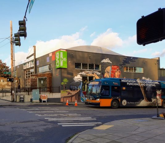 Metro Looks Toward Post-Pandemic Recovery, But Thorny Service Changes Could Be Ahead A Metro bus with the Evo store mural in the background.