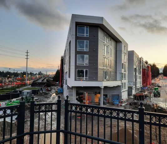 Shoreline Apartment Boom Picks Up Along RapidRide E, Still in Infancy Near Light Rail A new triangular shaped six-story apartment building at dusk.