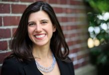 Jessyn Farrell Declares for Mayor, Promising Housing Push and Universal Childcare Farrell smiles with a brick background.