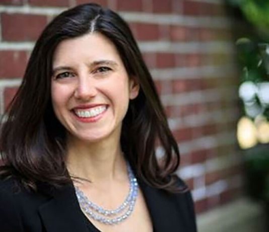 Jessyn Farrell Declares for Mayor, Promising Housing Push and Universal Childcare Farrell smiles with a brick background.