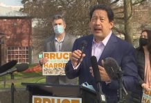 Bruce Harrell Would Follow the Data as Mayor, but Where Will It Lead Him? Bruce Harrell in a suitcoast with a microphone in hand at his candidacy announcement press conference.