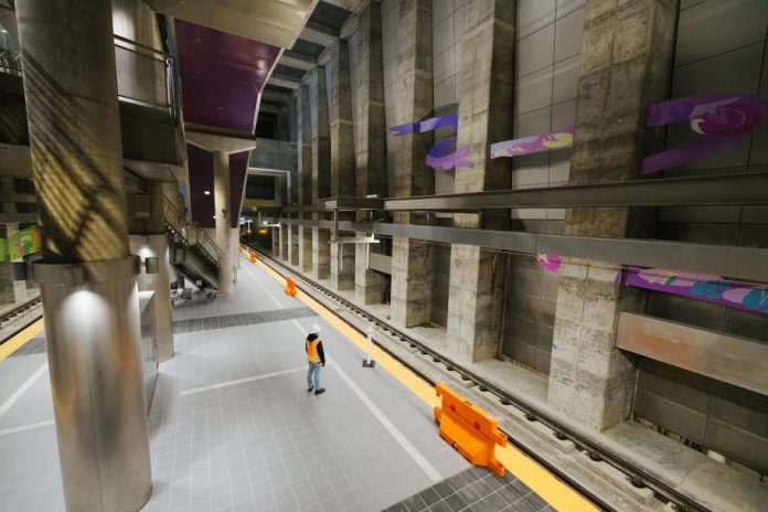 A construction stands on the underground station platform at Roosevelt Station.