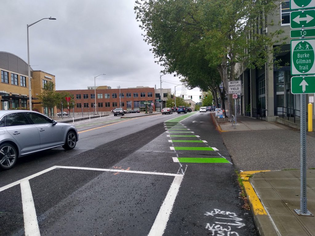 People biking westbound on N 34th St at Fremont Ave N have to navigate between several different lanes. (Photo by the author)