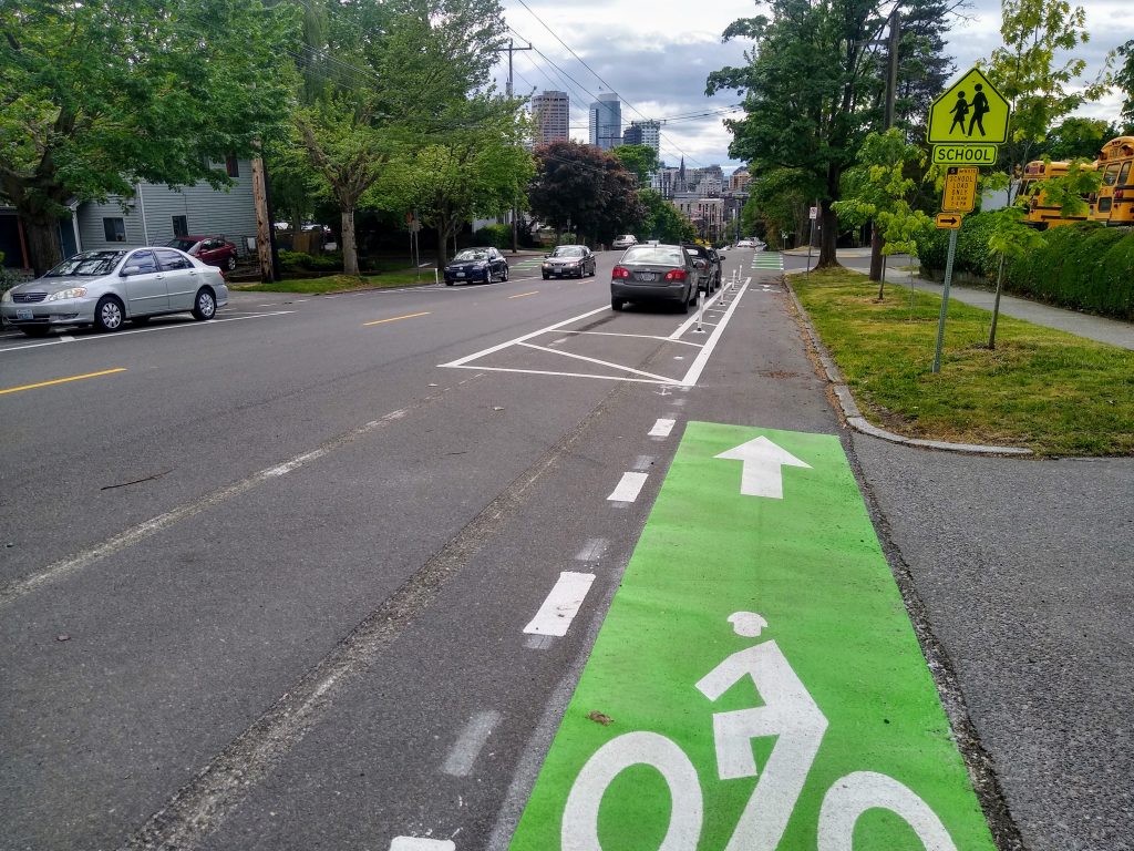 The new protected bike lane along E Union St took shape in May. (Photo by the author)