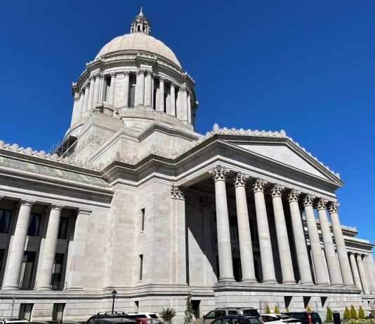 The Urbanist Podcast: Heroes and Zeroes 2023 The Capitol building in Olympia is marble colored and include pillars and a dome in the classic style.