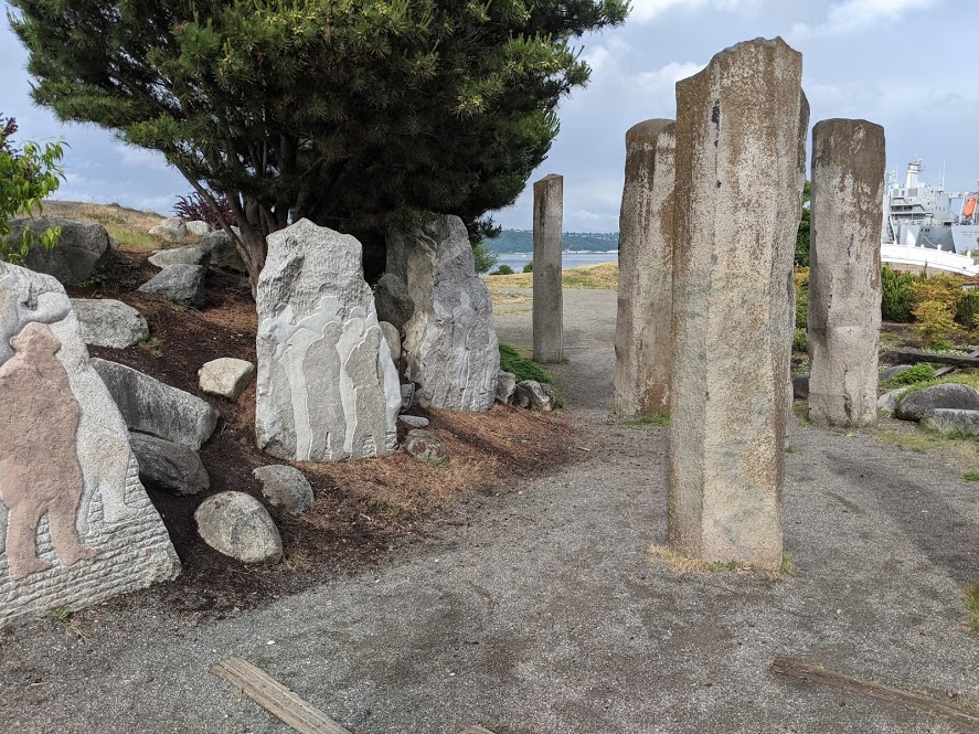 Carvings installed off the path symbolize the Chinese being expelled, pylons represent the Tacoma councilmembers. (Photo by author)