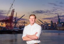 Ryan Calkins 2021 Questionnaire – Seattle Port Commission Pos. 1 Ryan calkins stands in front of cranes on the Seattle waterfront.