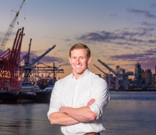 The Urbanist Podcast: The Port of Seattle with Commissioner Ryan Calkins Ryan calkins stands in front of cranes on the Seattle waterfront.