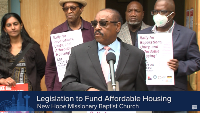 Senior Paster Robert Jeffrey Sr. stands with Councilmember Sawant and three supporters in the background at a press conference calling for reparations for New Hope church.