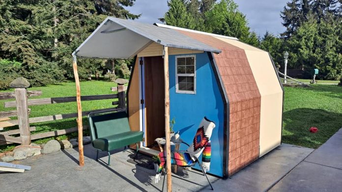 A view of a tiny house creation with a front porch from LiteHouse Shelters.