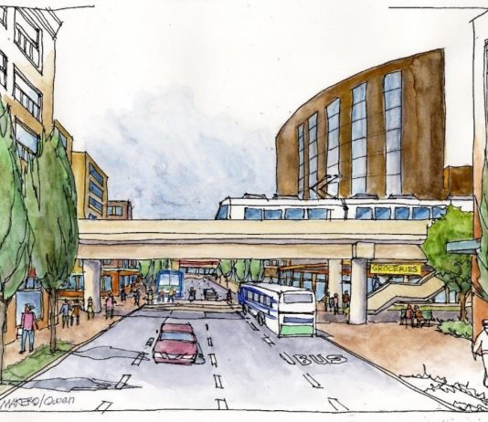 Direct I-5 and SR 99 Alternatives Reemerge for Everett Link Light Rail An elevated light rail line over a city street with midrise buildings on the sides.