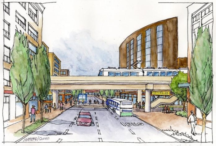 3450847da62470f38294bcf96ef0adde An elevated light rail line over a city street with midrise buildings on the sides.