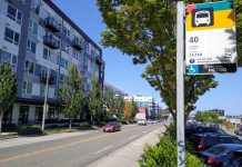 Business Interests Take Aim At Critical North Seattle Transit Corridor Improvements A bus stop along a four lane busy road reading "40"
