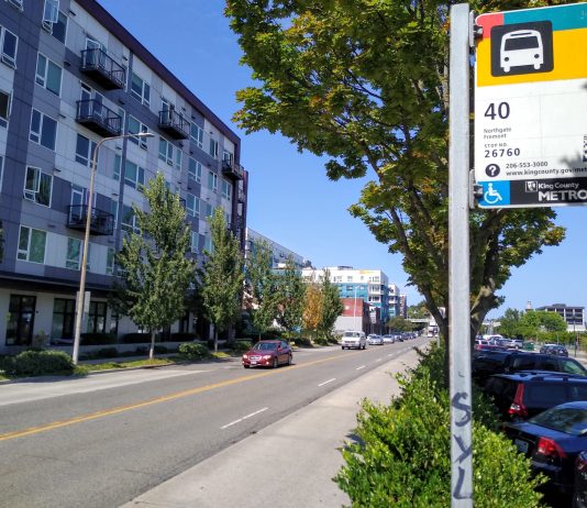 Business Interests Take Aim At Critical North Seattle Transit Corridor Improvements A bus stop along a four lane busy road reading "40"