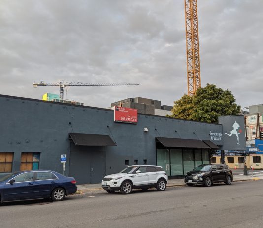 Harrell Hopes to Fill Downtown Storefronts by Easing Code Restrictions Serious Pie and Biscuit is shuttered. Construction cranes tower in the background.