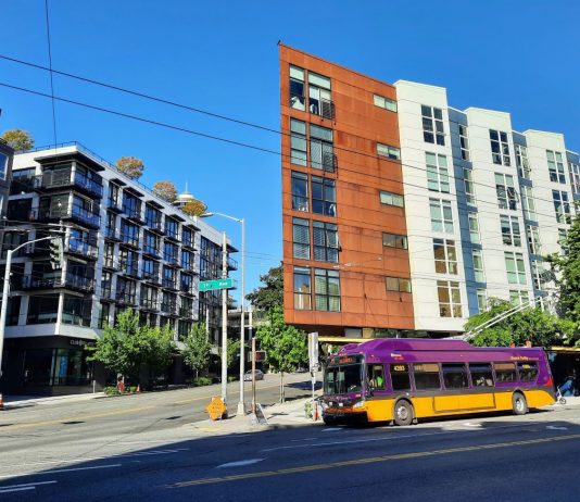 What It Would Take for Seattle to Lead on Climate A Route 33 trolley bus at the intersection 1st Avenue and Denny Way with low-rise apartment buildings behind.
