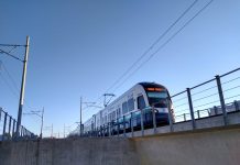 Seattle Subway Urges Lawmakers to Adopt Rail Funding Fix A photo of a light rail train on an elevated rail line.