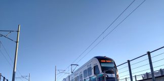 A photo of a light rail train on an elevated rail line.