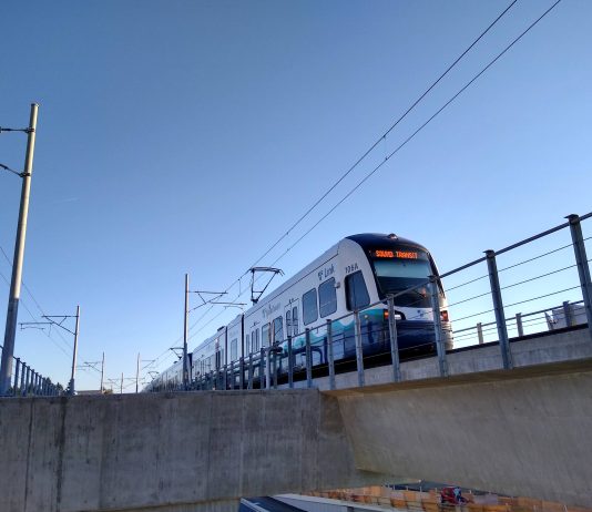 Seattle Subway Urges Lawmakers to Adopt Rail Funding Fix A photo of a light rail train on an elevated rail line.