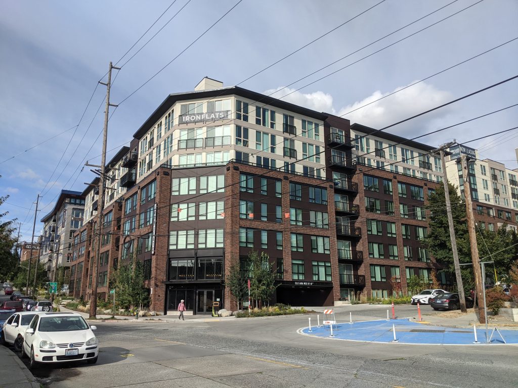 One of three buildings of the Iron Flats apartments, a second building peeks out of the right.