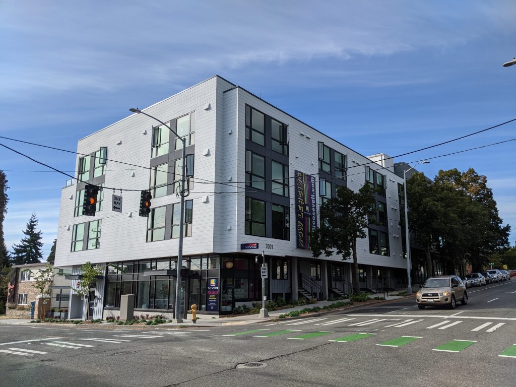 A photo of two apartment buildings, Vivid Apartments in front and Vista 7011 behind