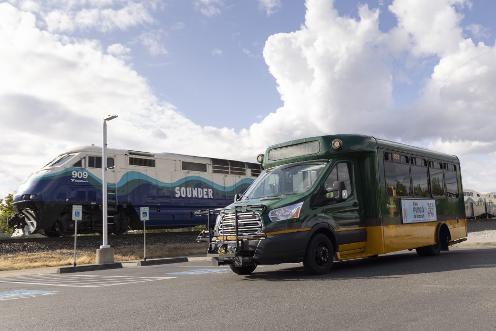 A Pingo to Transit van parked with a Sounder train in the background.