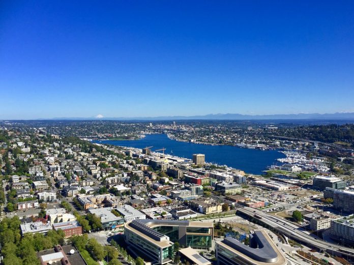 A photo showing an aerial view of Seattle looking north from the Space needle, housing, roads, and Greenlake are all visible.