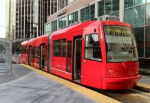 The Case for Streetcar Lines to Magnolia and Fremont A photo of a bright red streetcar.