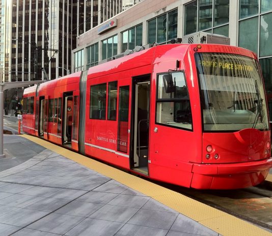 The Case for Streetcar Lines to Magnolia and Fremont A photo of a bright red streetcar.