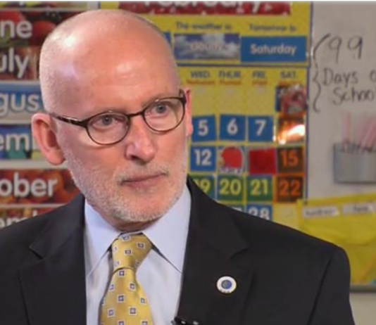 Appeal Denied: Compassion Seattle’s Charter Amendment is Dead Tim Burgess is a bald white man with glasses dressed in a dark suit and yellow tie.