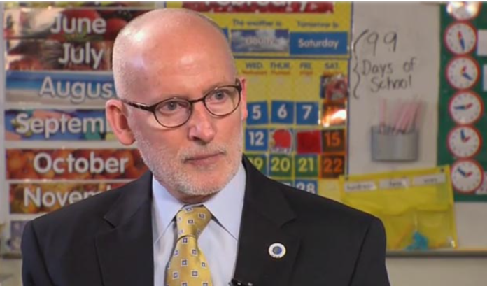 Tim Burgess Seattle Councilmember by Seattle Channel Tim Burgess is a bald white man with glasses dressed in a dark suit and yellow tie.