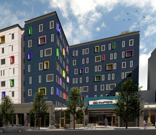 Pride Place Senior Housing Breaks Ground in Capitol Hill A rendering of a "L" shaped seven story apartment building. Three quarters of the exterior of the building is dark grey, while one quarter is white. The windows are surrounded by frames in many different vibrant colors.