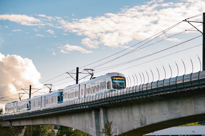 sound-transit-train A view of an elevated light rail track with a train approaching.